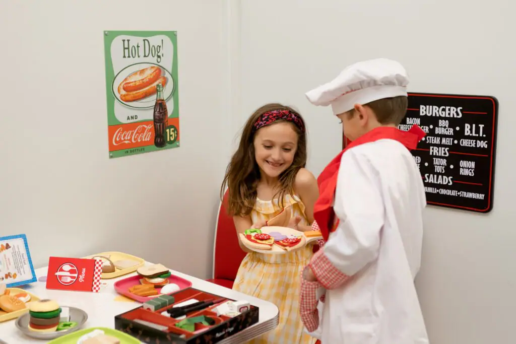 Children using the diner pretend-play station at Kids Hideout.