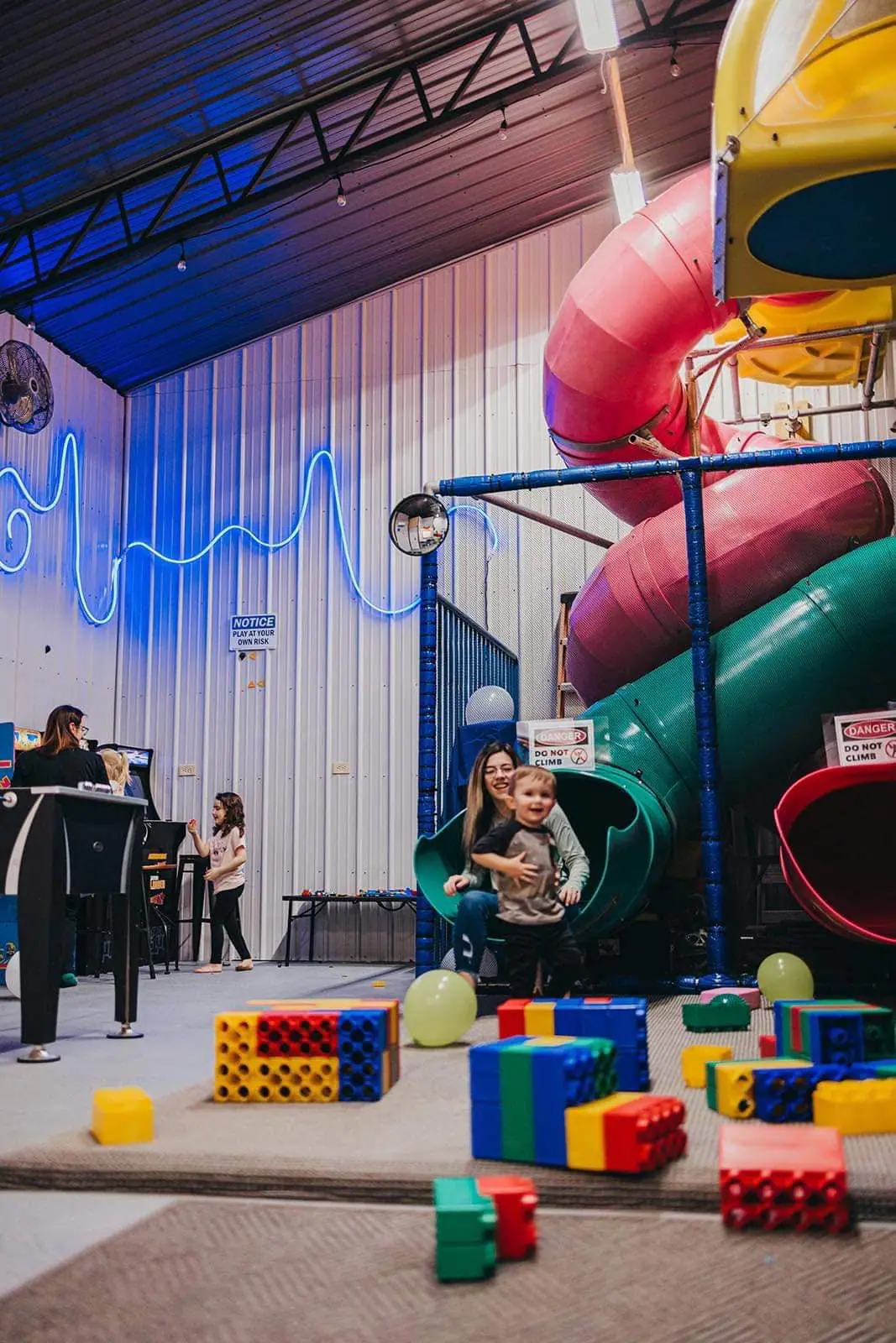 Indoor playground and slide structure inside Party Barn in Manitou.