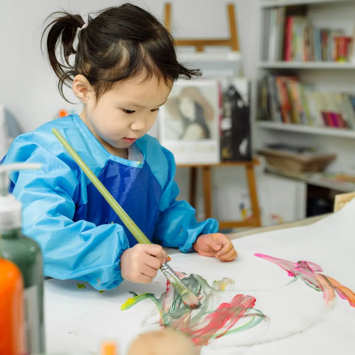 Child painting during an activity at Create & Play Kids.