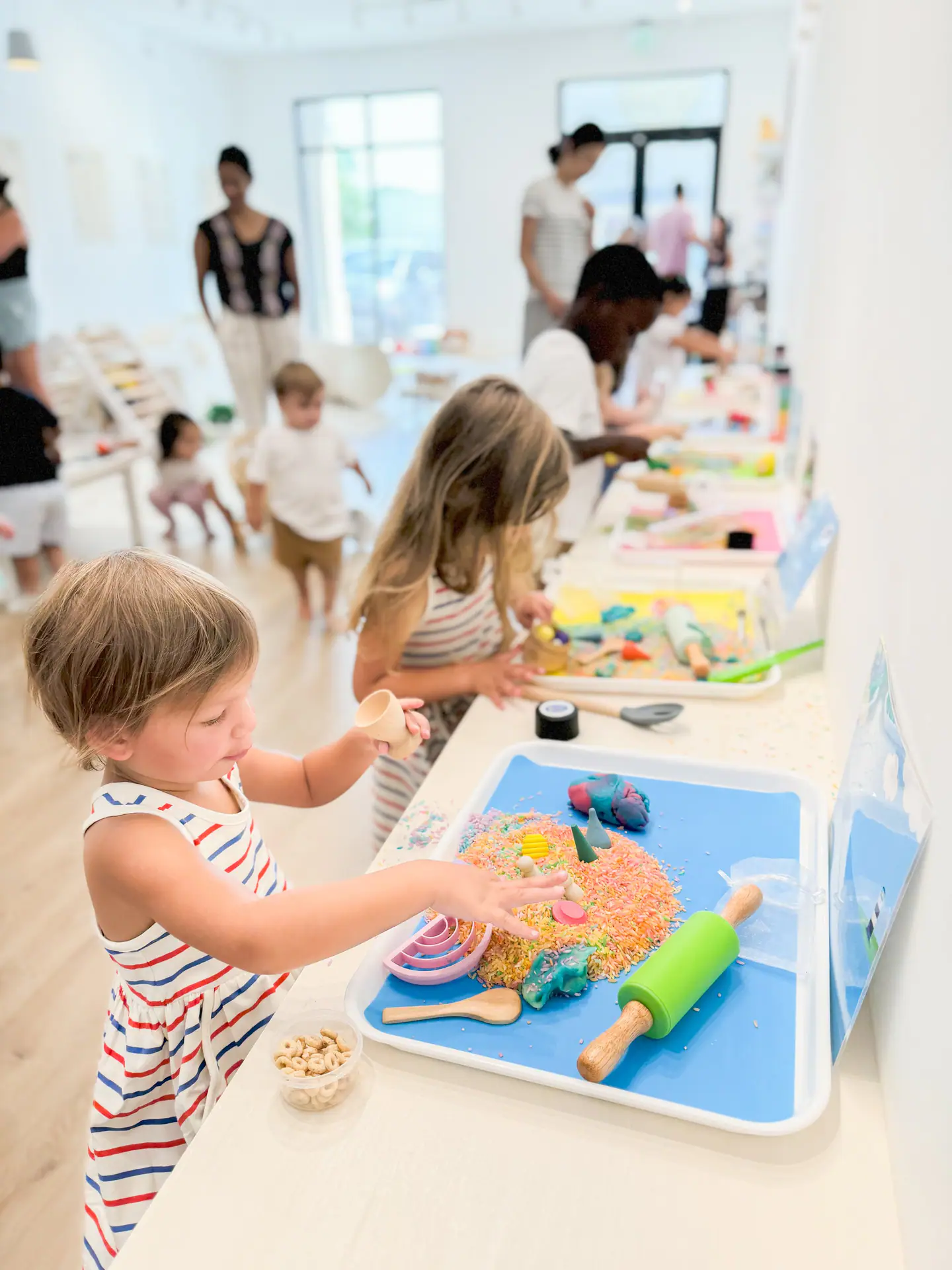 Sensory table setup for young children inside Create & Play Club.