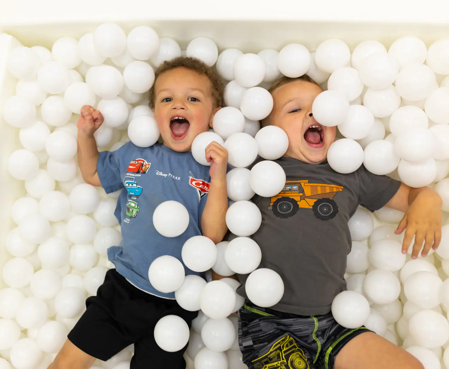 Children playing in the whimsical play zone at Goose & Giggles Play Cafe.