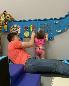 Adult and toddler using the sensory wall inside Imagining With Me