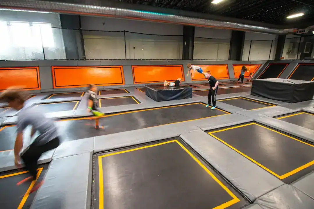 Kids climbing on the interactive wall attractions at Trampoline Zone & Adventure Park.