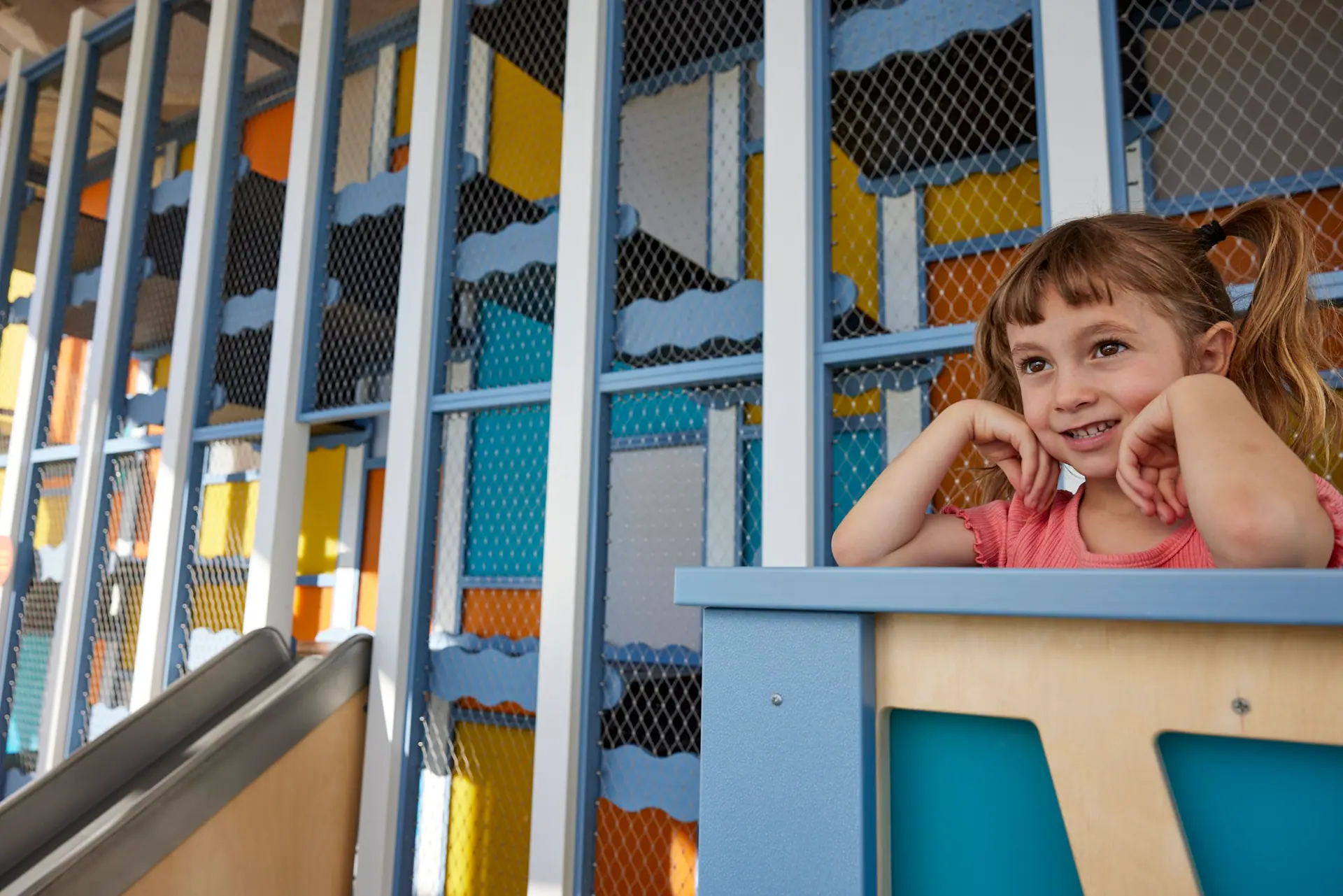 Child beside the indoor climbing area at CMTM.