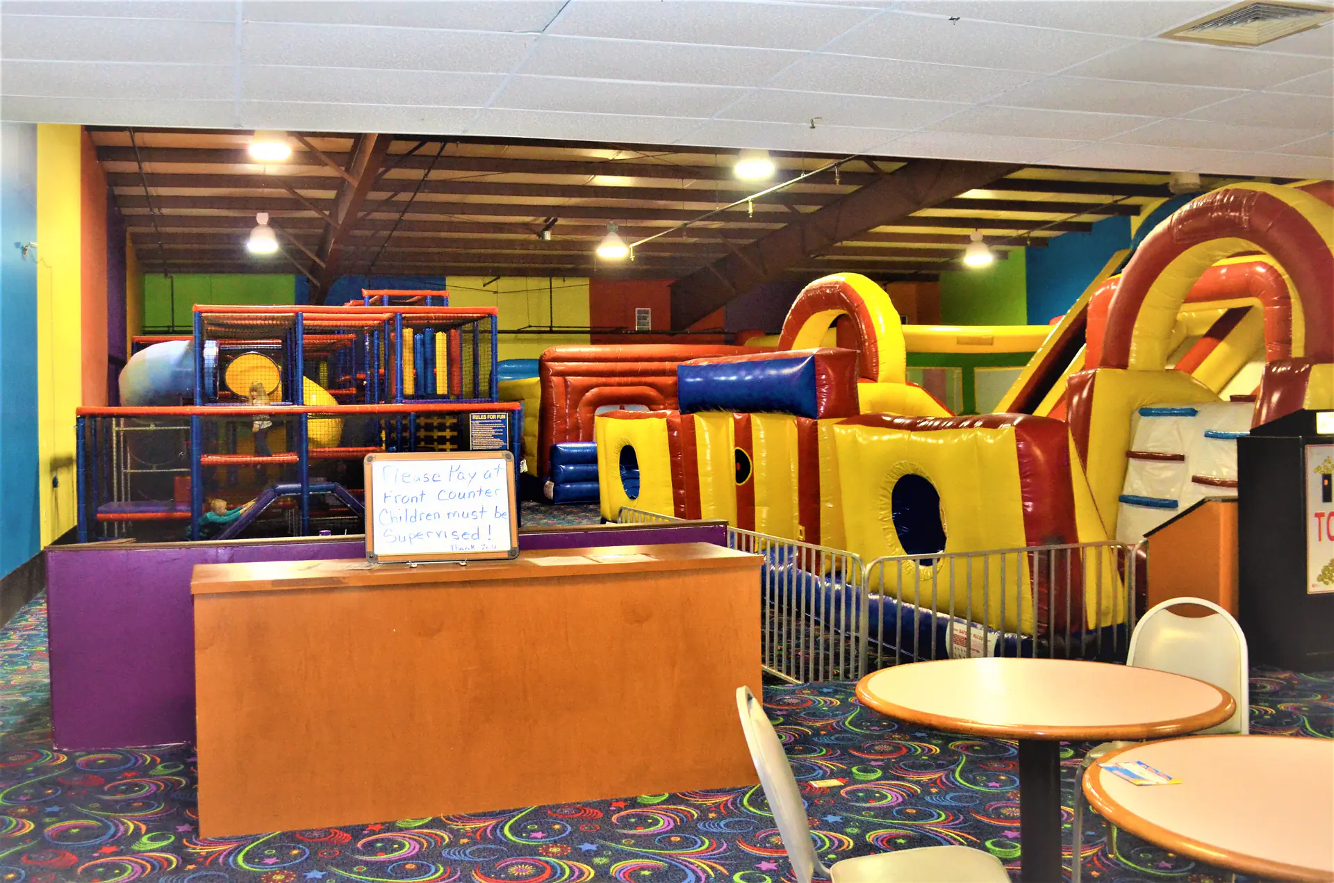 Children playing in the climbing and arcade area at Strikerz Party & Play.