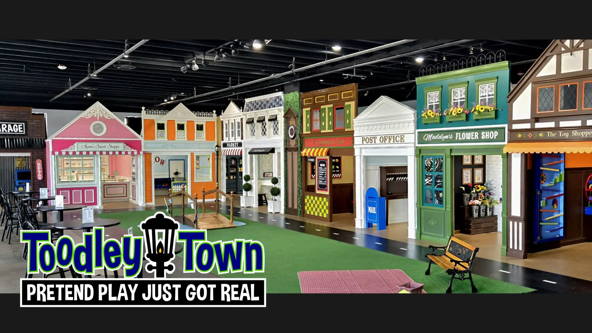 Children exploring the pretend-play indoor town at Toodley Town in Las Vegas.