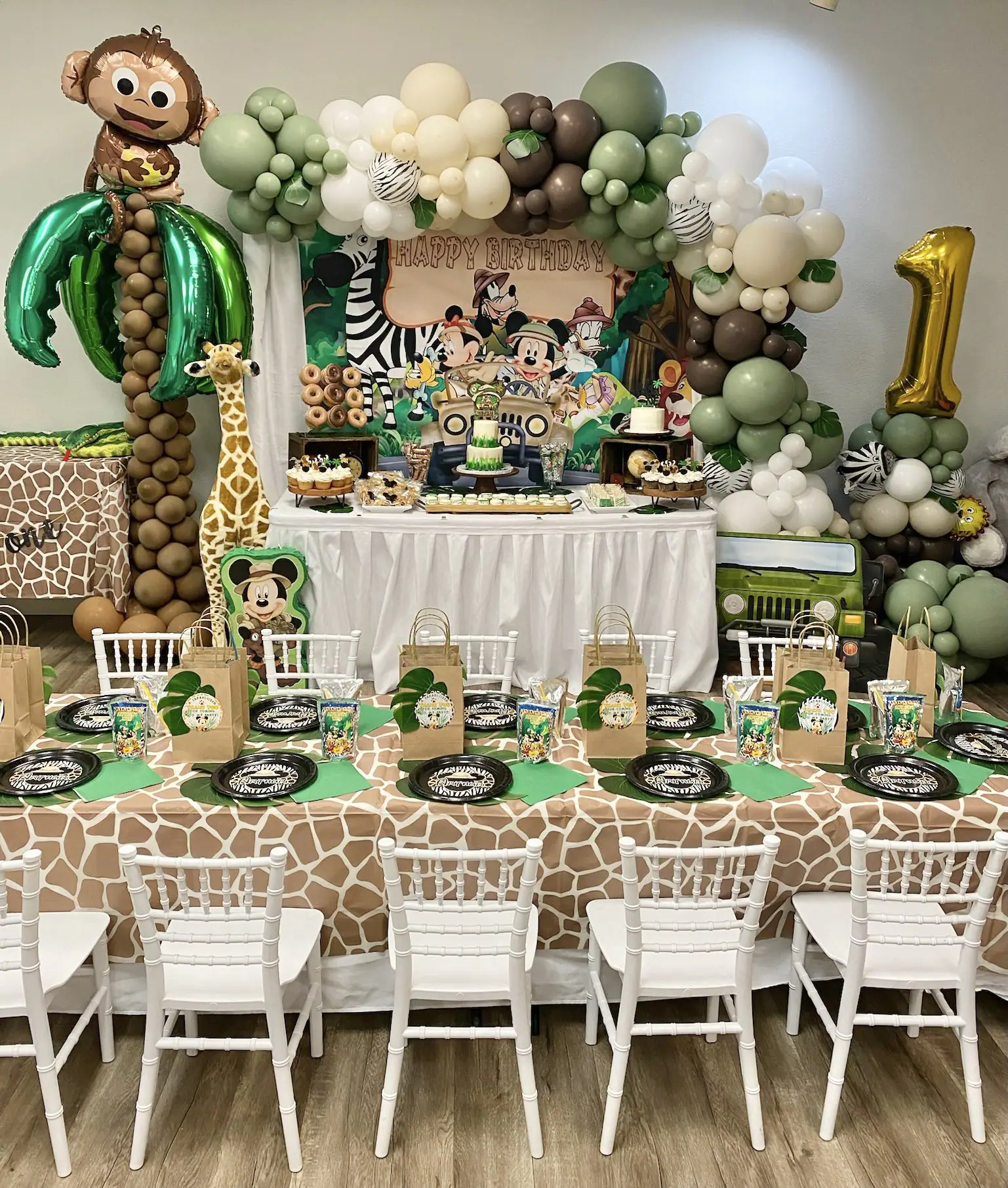 A decorated safari-themed party setup inside Wigglin' Out Indoor Playground.