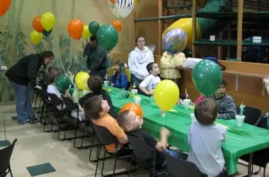 Birthday party setup with long tables and balloons at Jungle Java Clinton Township.