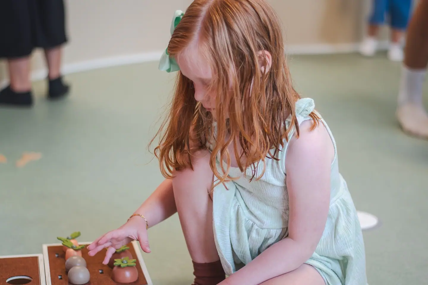 Child using a tabletop play activity at Little Town.