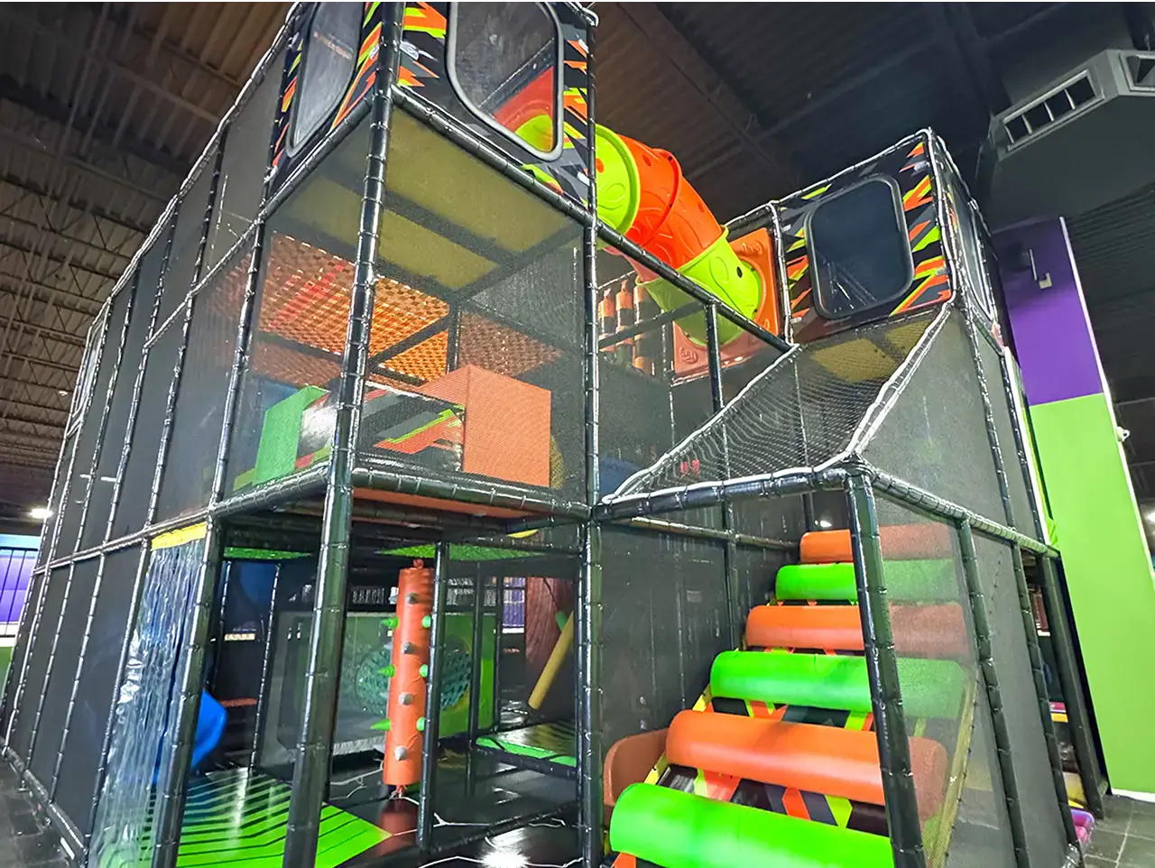 Indoor playground and soft-play structure inside Jump City Trampoline Park in Louisville.
