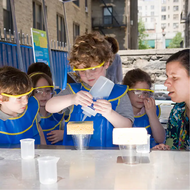 Children exploring an interactive science and water-style activity at CMOM.
