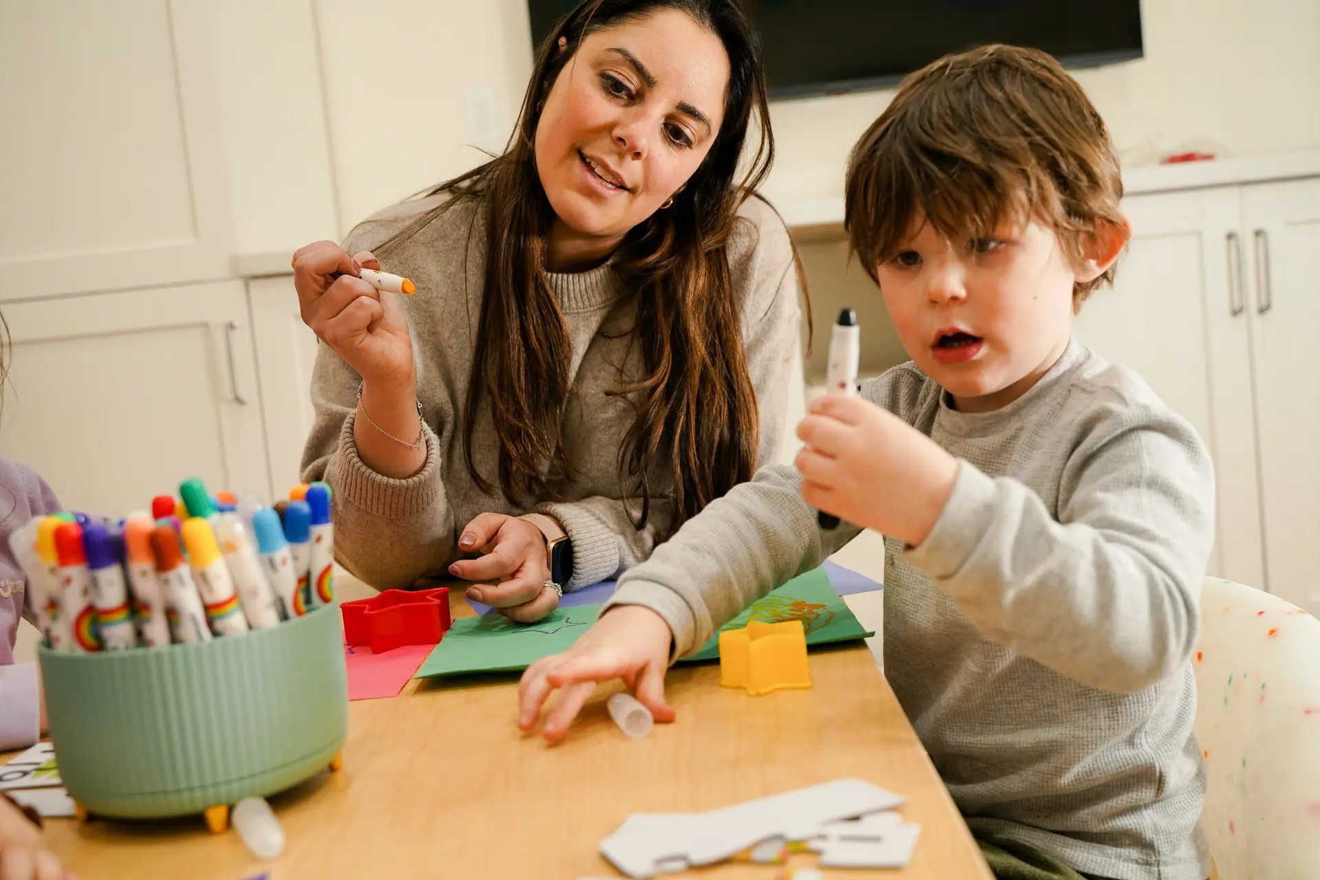 Caregiver and child working on a craft at Spark Place in Jersey City.