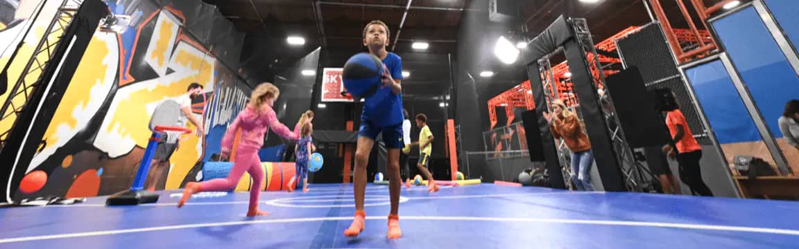 Kids using an indoor court attraction at Sky Zone Scottsdale