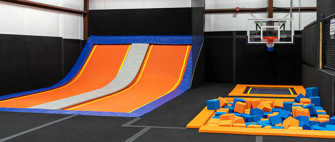 Wide view of trampoline attractions and padded play zones at Ultimate Air Stillwater.