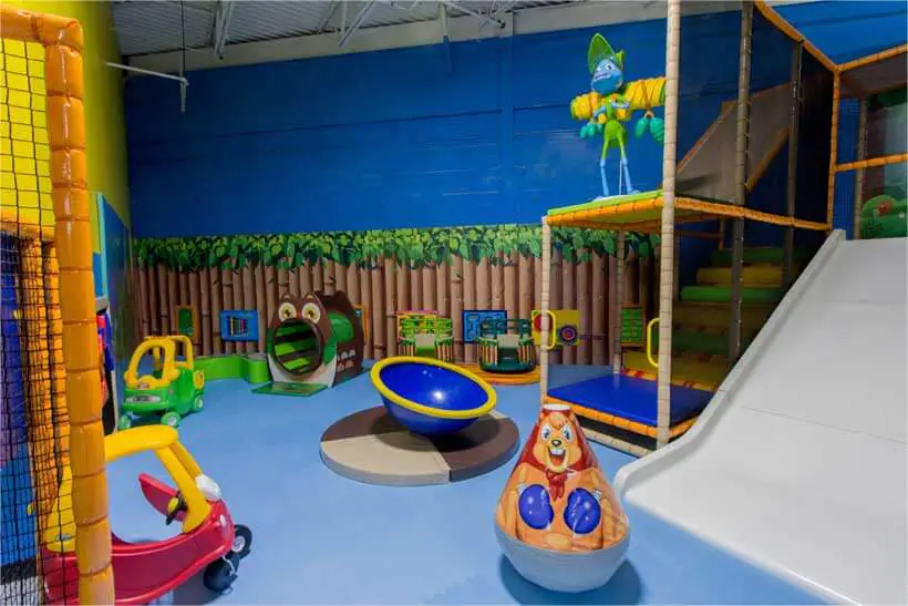 Children climbing and playing on large indoor attractions at Funzilla.