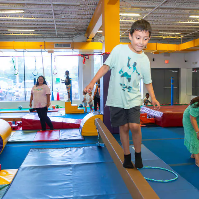 Child balancing during play at Tumble Jungle in Norwalk