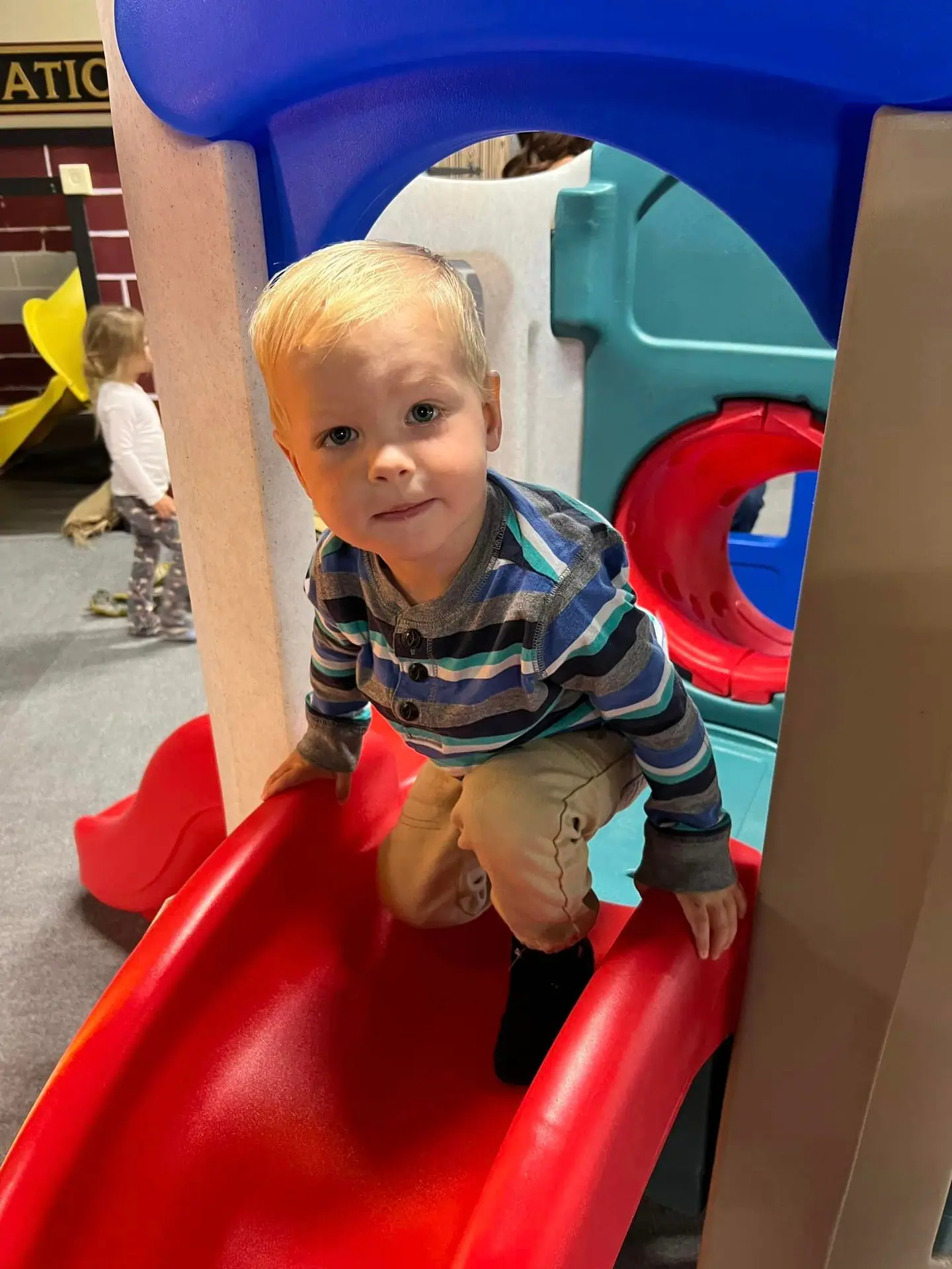 Indoor play structure and slide at Imagination City in Abilene.