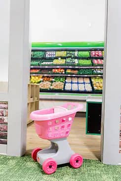 Pretend grocery play area inside Little Explorers Play Cafe.