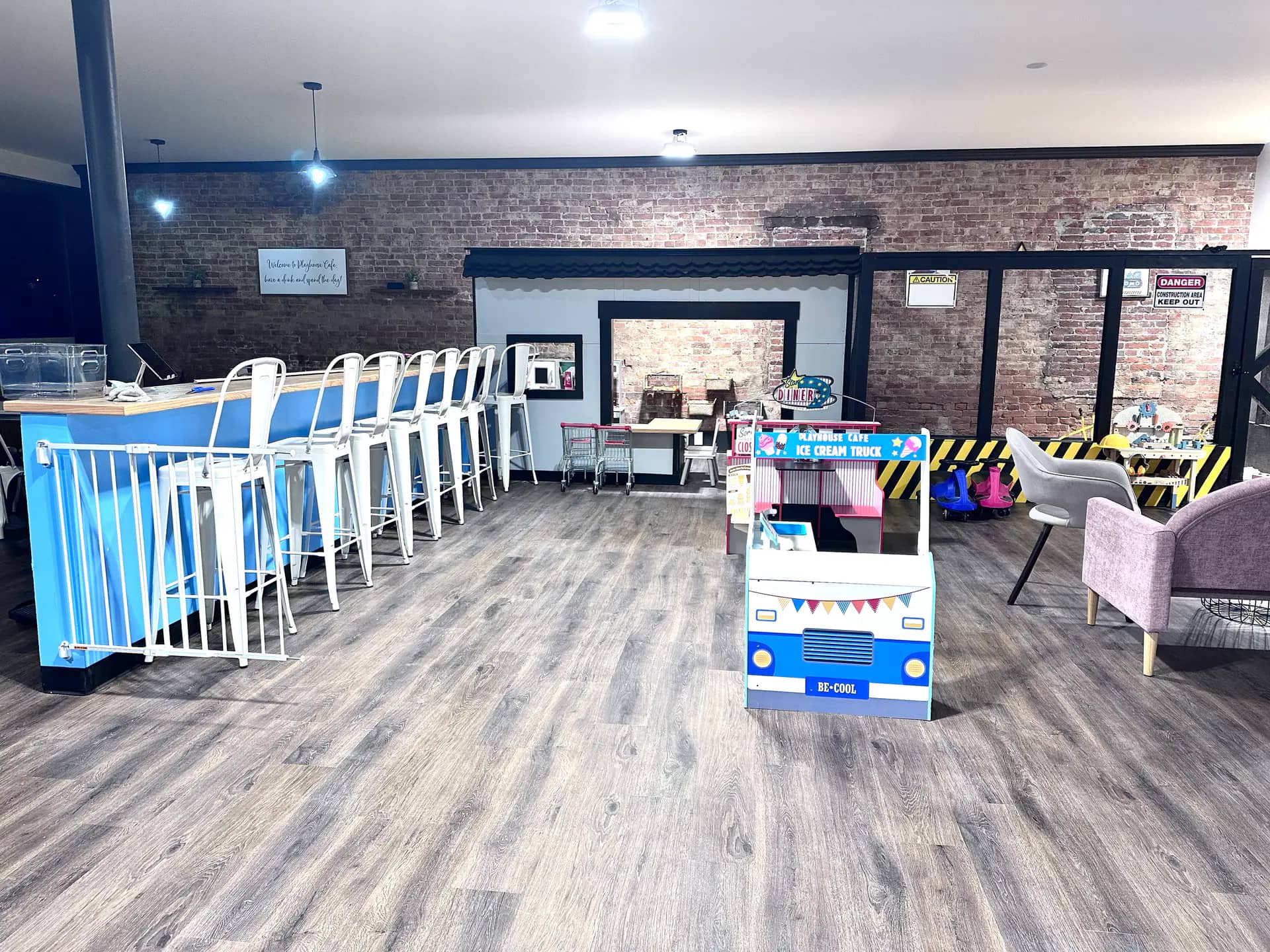 Playhouse Cafe interior with café seating beside the indoor play area in Madison