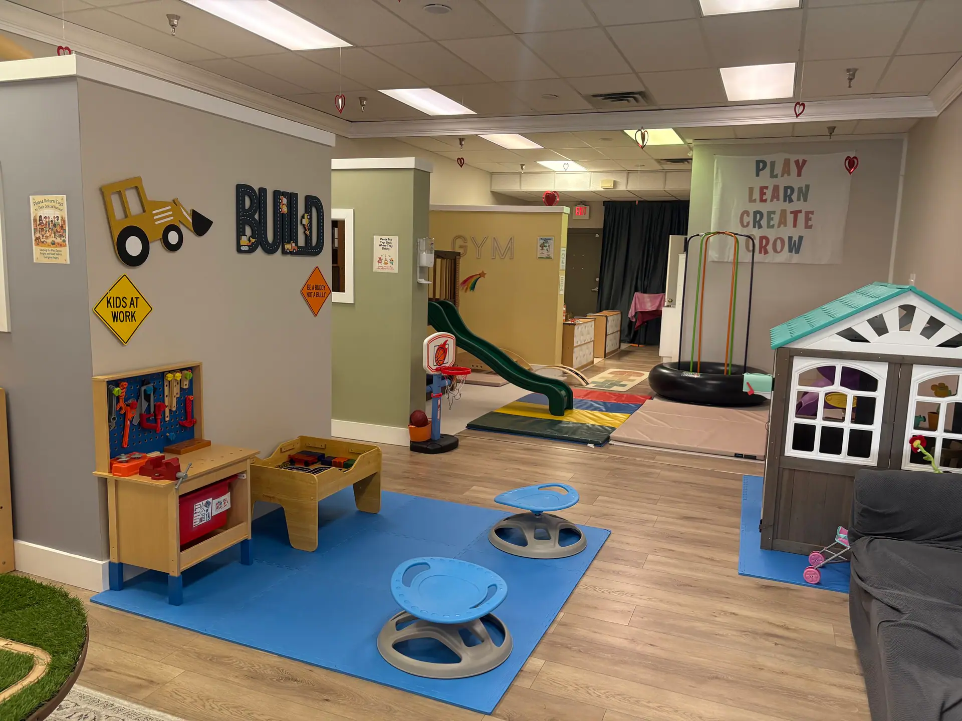 Main play floor at Kidscape Playground, with pretend-play stations, soft movement equipment, and toddler-friendly play areas.