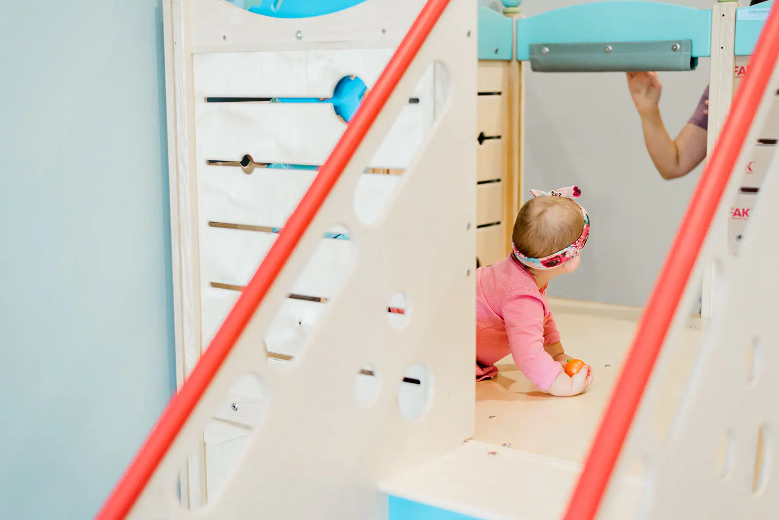 Montessori-inspired play area with natural-toned play equipment at Play Factory and Cafe.