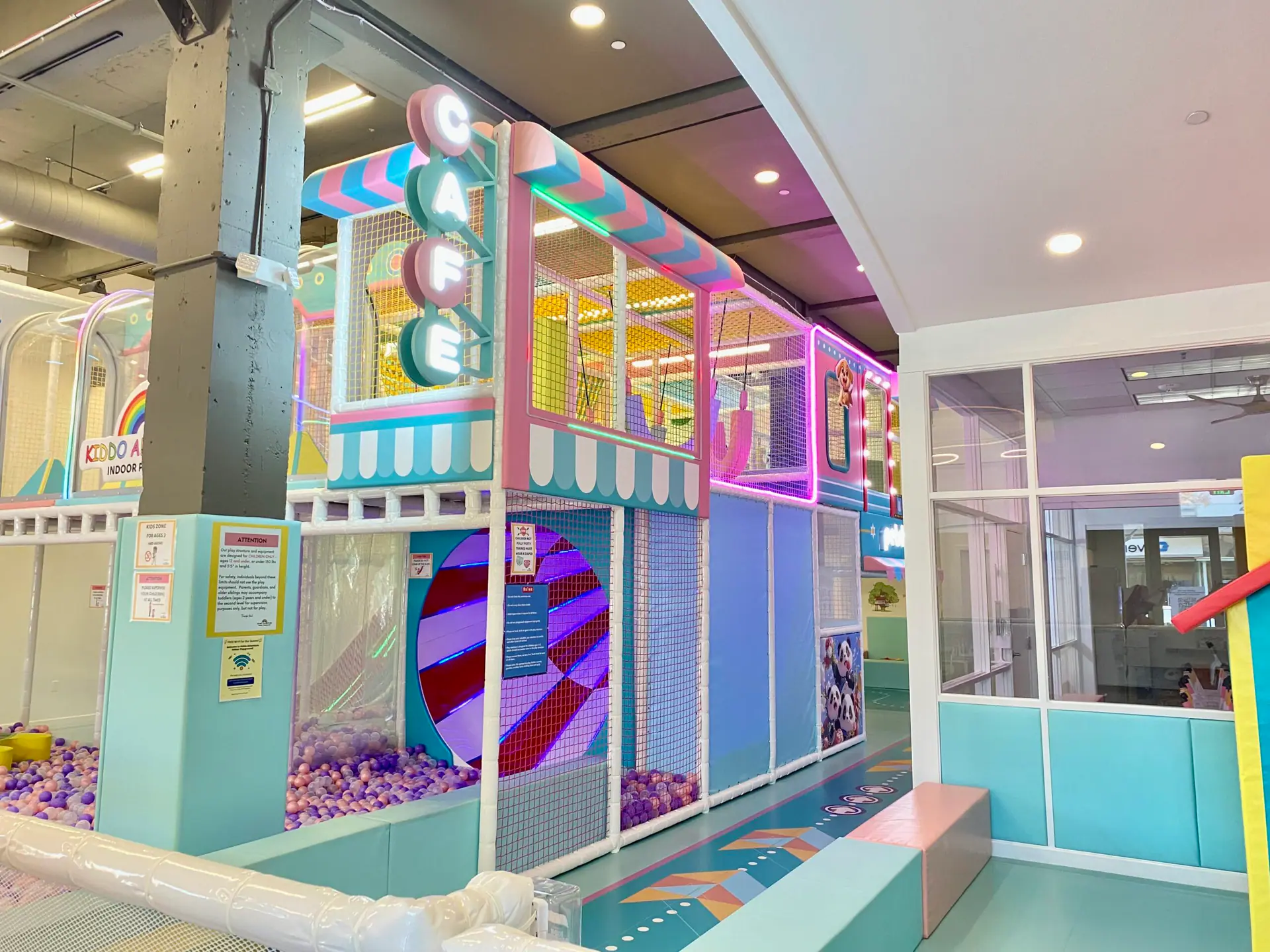 Front cafe and seating area beside the play structure at Kiddo Adventure.