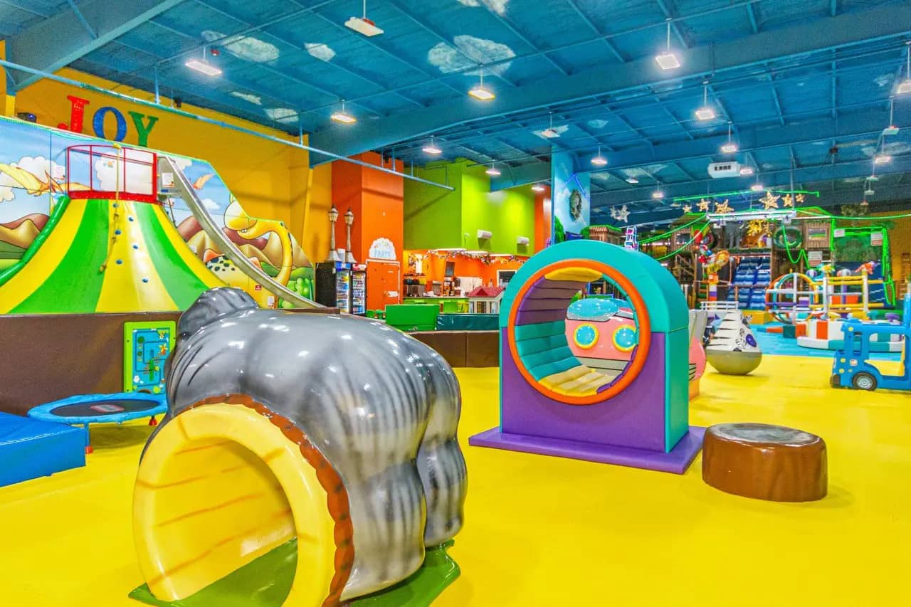 Open play floor with crawl-through and climbing features at Newtopia Fun Park.