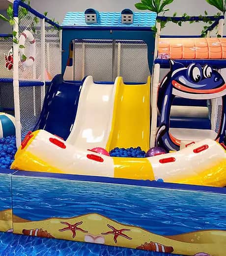 Indoor play equipment and slide area at Fun N Play Indoor Playground in Cypress.