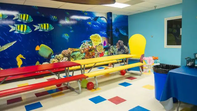 Colorful party seating area inside The Playground for Kids.