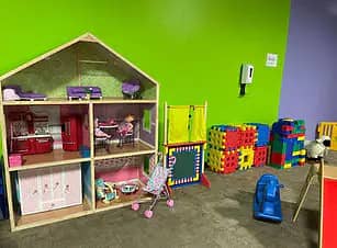 Pretend-play dollhouse area inside Children's World Indoor Playground.