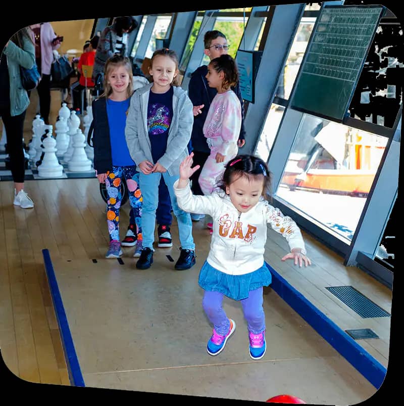Children playing in the Big Games exhibit at Staten Island Children's Museum