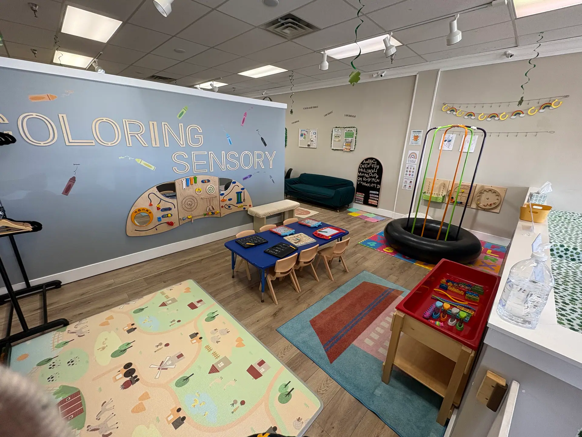 Sensory room at Kidscape Playground with low tables, tactile wall activities, and calming play equipment.