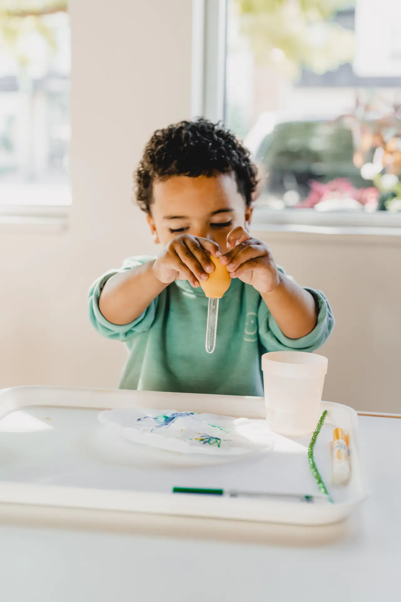 Young child doing a sensory-style class activity at The Play Group.