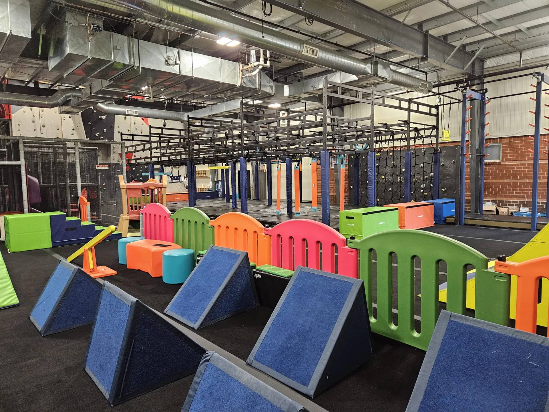 NinjAdventure Zone at AYCC with obstacle elements and a smaller play area for younger children.