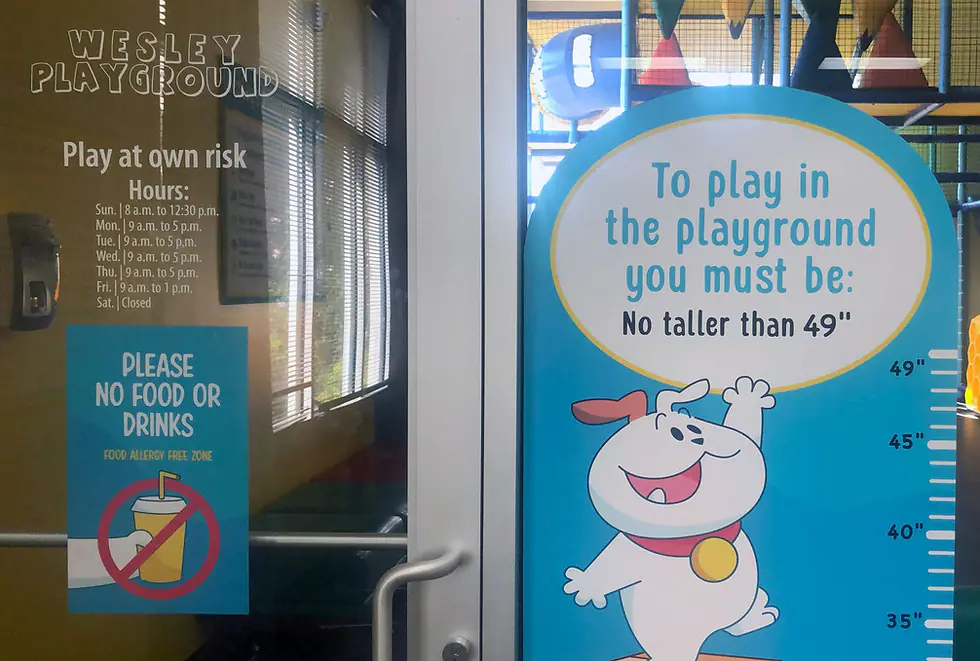 Wesley Playground entry signage with height limit and hours