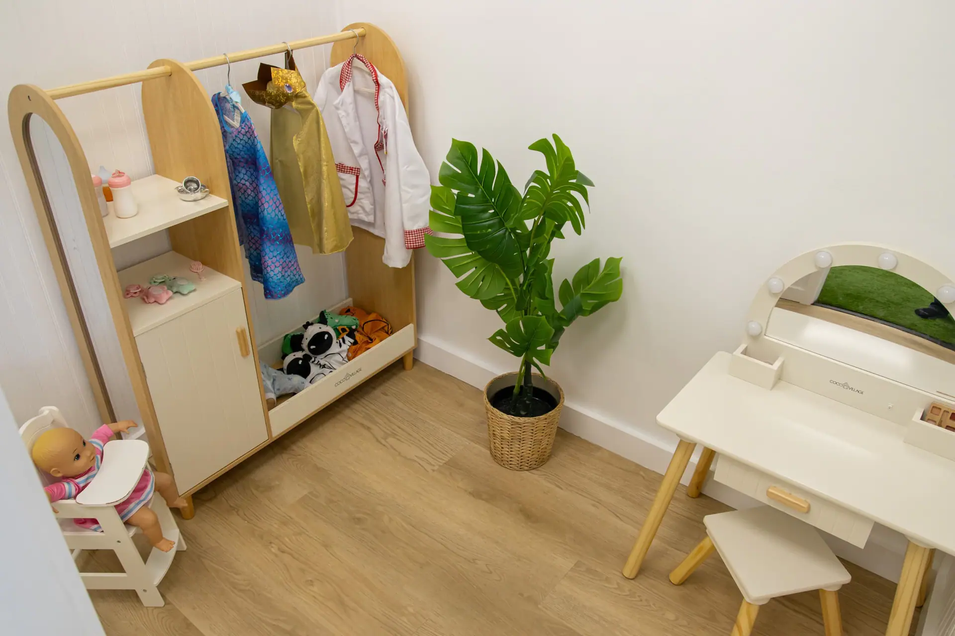 Dress-up and vanity corner with costumes at Little Leaps Play-Cafe.