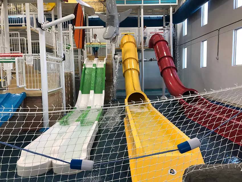 Close-up of the slide section inside Splash Shack with multiple kid-sized water slides.