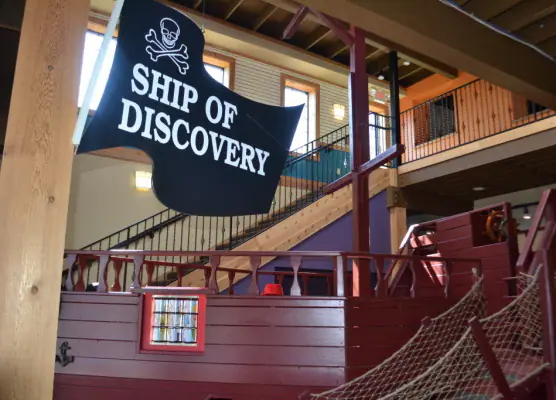 Large ship-themed exhibit inside The Children's Play Gallery.
