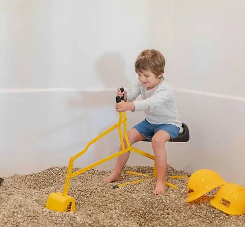 Child using construction-style sensory play at Dorothy's Playhouse.