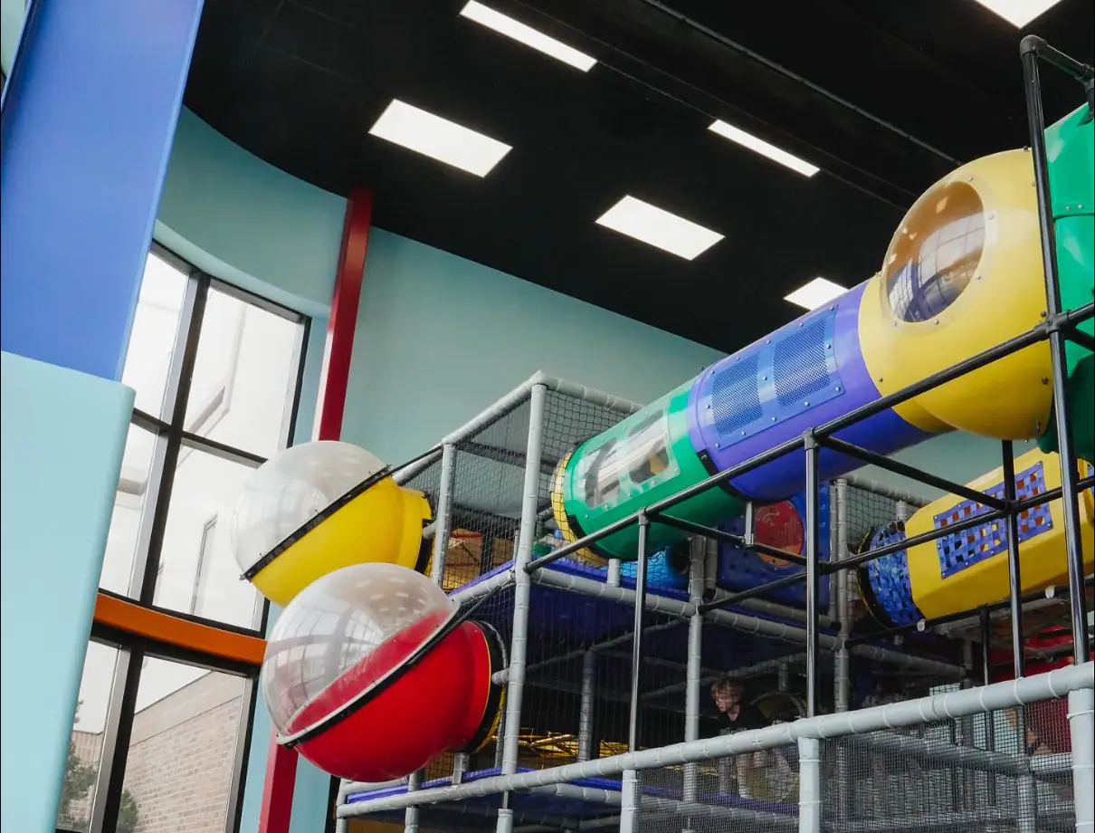 Indoor play structure and seating area at The Naz Commons Playplace in Grove City.