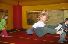Another angle of the Jump N Jax play space with padded equipment and open floor area.