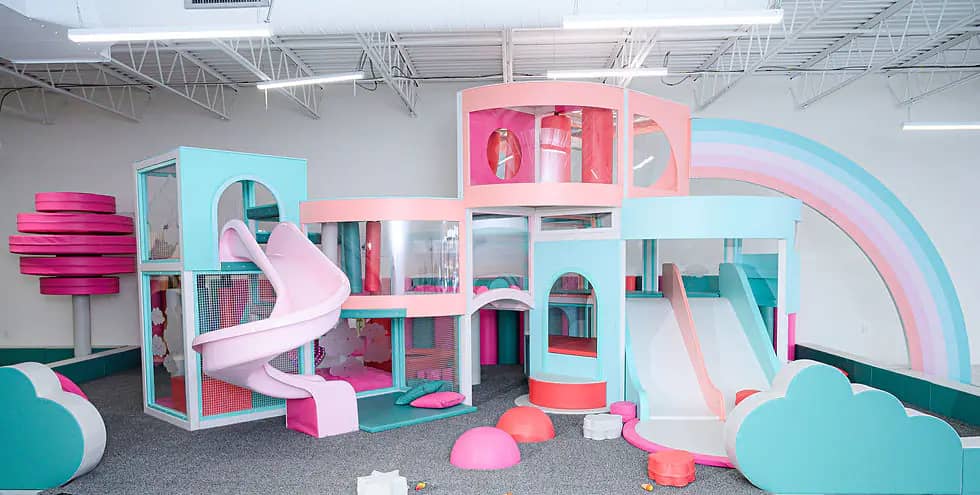 Modern indoor play area with slides and soft-play features at Mamas Play.