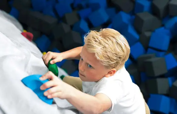 Child climbing FreeClimb wall at Sky Zone.
