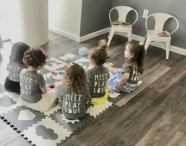 Young children sitting together during a small group activity at The Little Play Co.