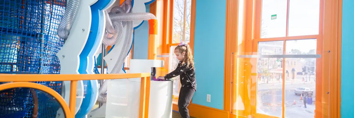 Children exploring museum exhibits at CMOO