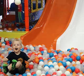 Child in the tubes playground and ball pit area at Xtreme Jump Adventure Park in Temple.