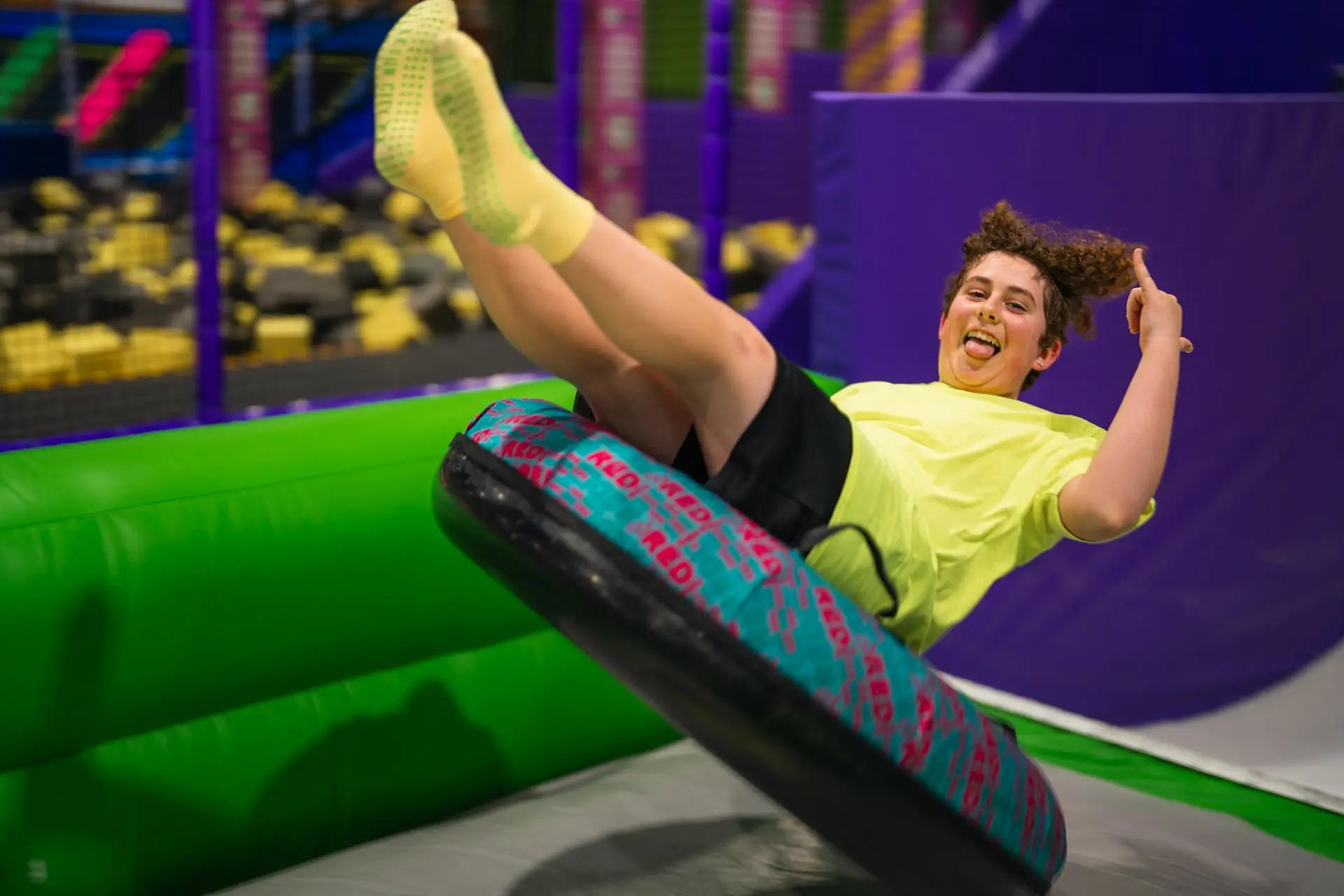 Rider on a spinning tube attraction inside Fun City Adventure Park